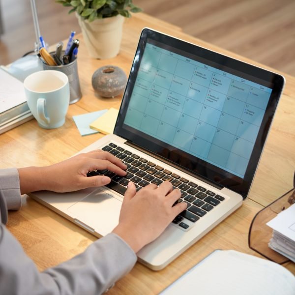 Filling online calender Business woman making schedule for the month
